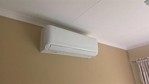 Wall-mounted split unit in a home living room