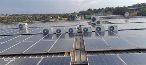 Outdoor units on a rooftop among solar panels