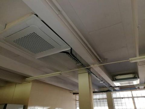 Cassette units in an exposed office ceiling