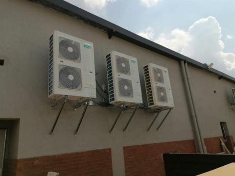 Outdoor condensers mounted along a wall