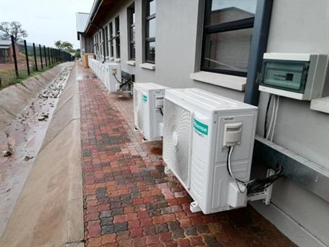 Row of outdoor condensers on brick paving