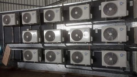 Wall of outdoor condensers stacked in rows