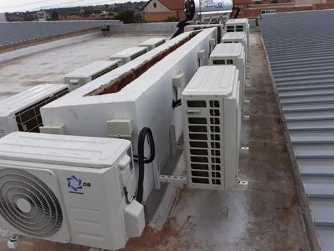 Rooftop outdoor units around a planter