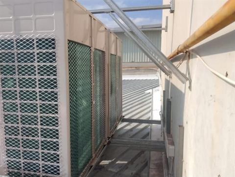 Large outdoor units behind protective screening